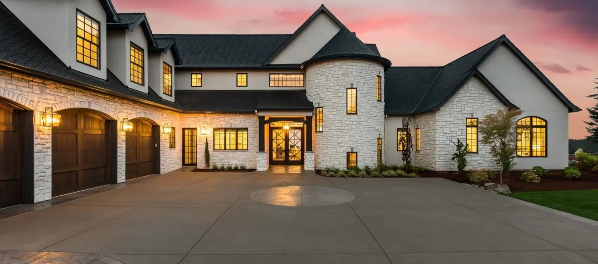Luxurious suburban home with stone facade at dusk.